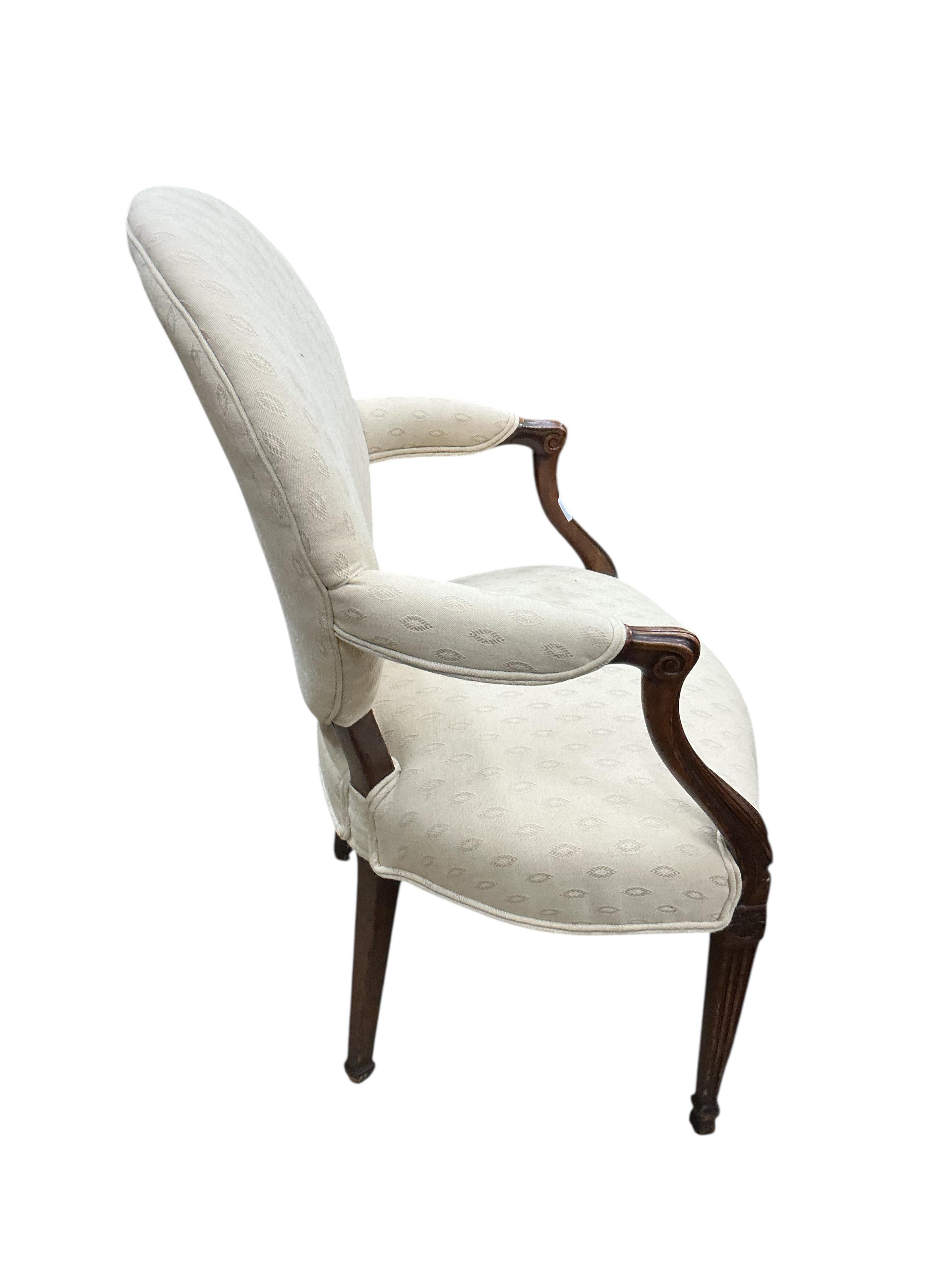 A George III Hepplewhite style upholstered mahogany elbow chair, width 61cm, depth 44cm, height 94cm